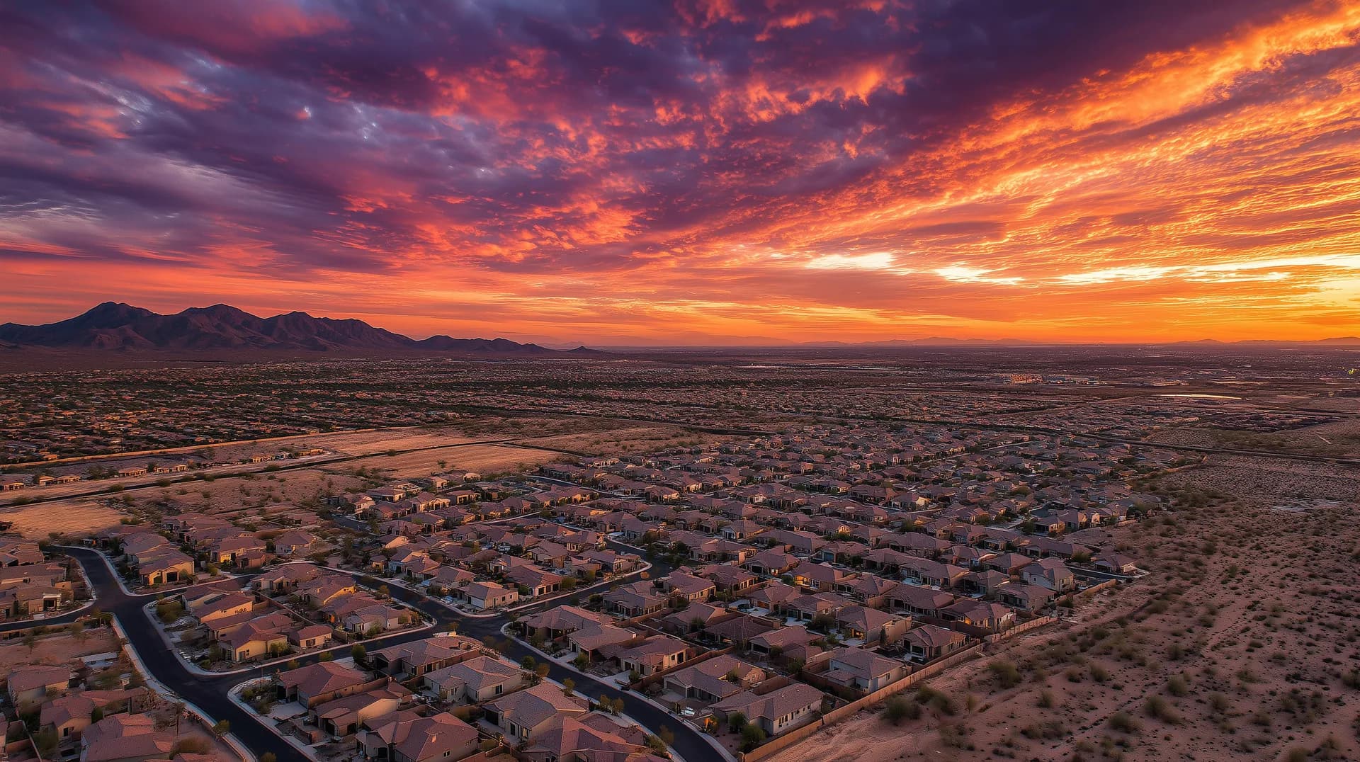 West Valley new construction neighborhood at sunset with dramatic orange and purple sky