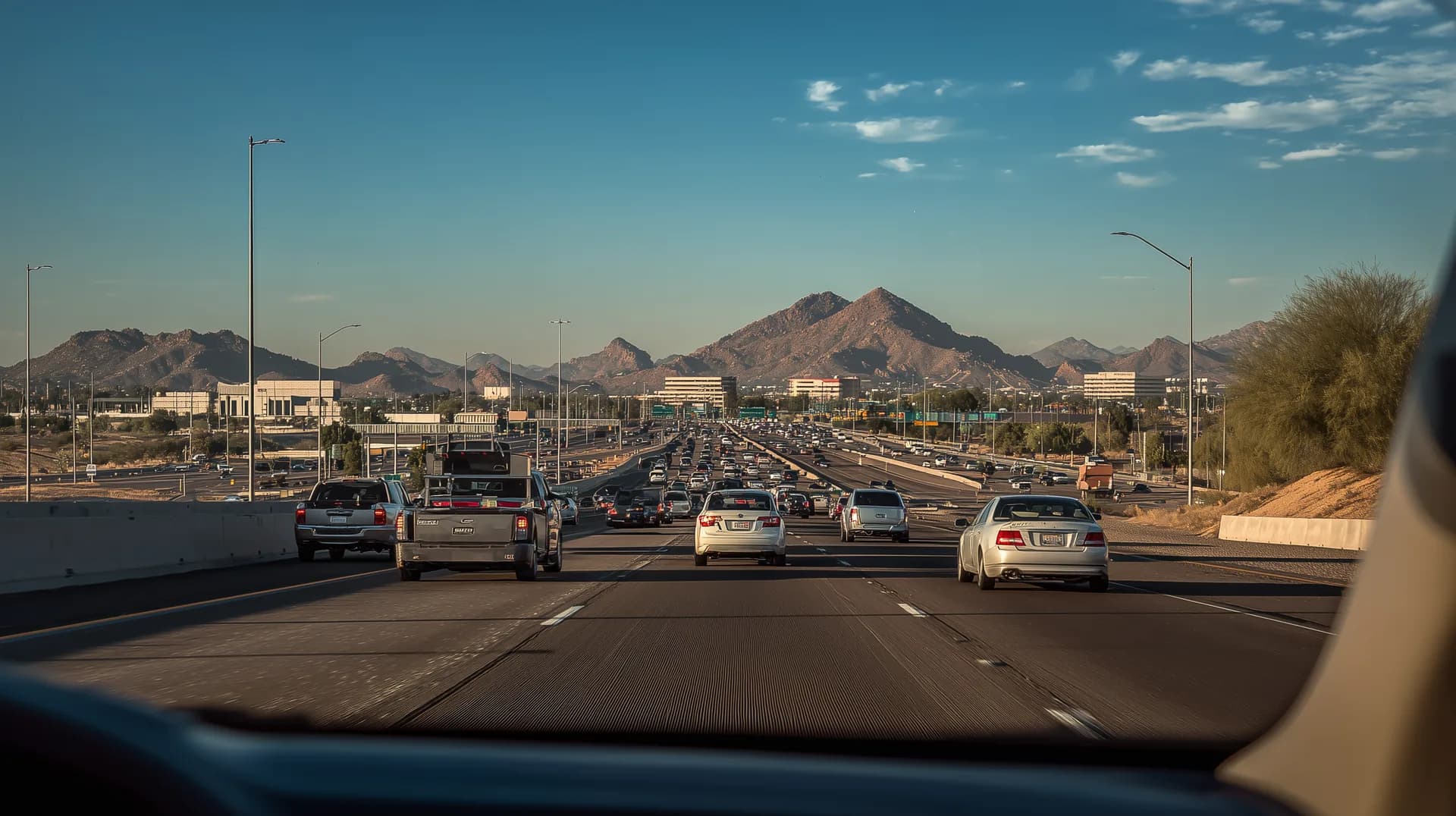 Phoenix freeway from driver perspective during morning rush hour with mountains ahead